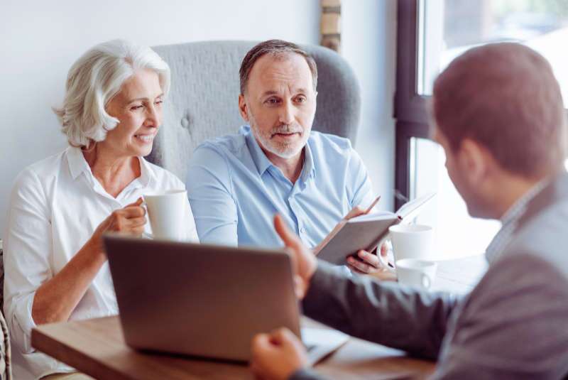 Couple consulting with their financial advisor.