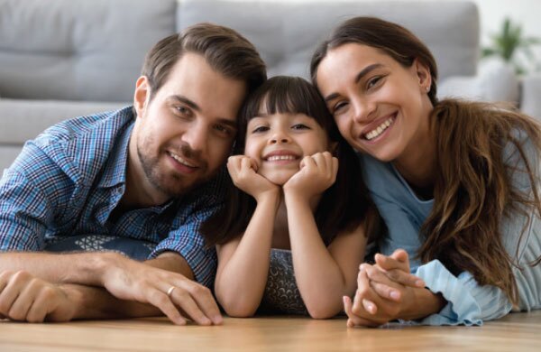 A happy family leaning on a coffee table, representing the professional standard of care and a personalized financial planning process.